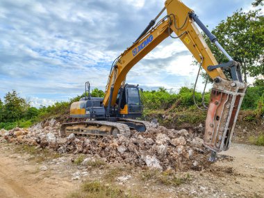 Endonezya, 28 Haziran 2024 - Endonezya, 28 Haziran 2024 - İnşaat veya kazı sahalarında sert kayaları ezmek için hidrolik kırıcı çekiçli Crawler kazıcısı - Hidrolik Jack Bağlı Kaya Kırıcı