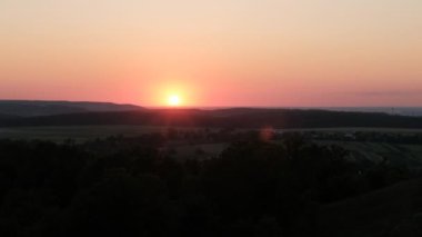 Landscape view of the sun goes down on horizon, beautiful sunset with natural sunflare