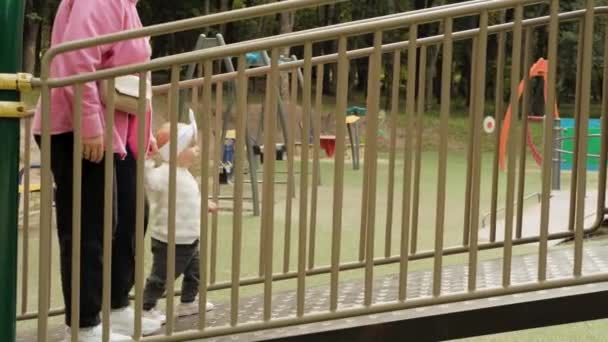 Mother Helping Her Baby Girl Walking Playground Mom Little Child – stockvideo
