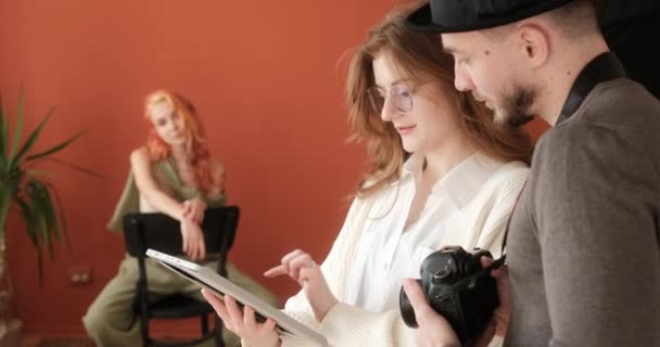 Fotograf Asystent Przy Użyciu Tabletu Omawiając Sesję Zdjęciową Studio Podczas — Wideo stockowe