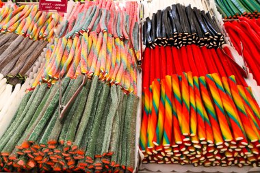 Colorful candy stall in the market. Licorice. clipart