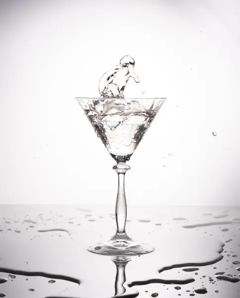 Splash from pouring martini into the glass. High quality photo