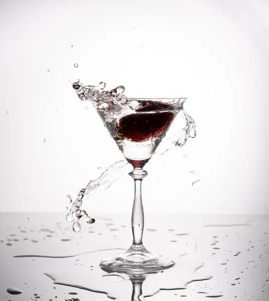 Splash from pouring martini into the glass. High quality photo