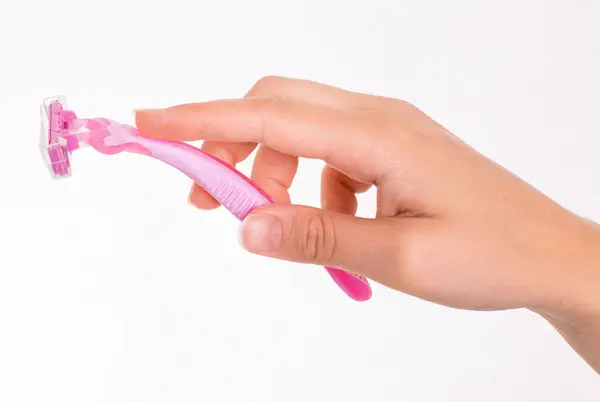 stock image pink razor in female hands isolated on a white background