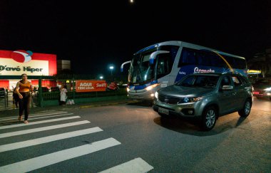 Suzano, Sao Paulo - Brazil - June 23, 2024: One of the busiest points in the city of Suzano, where there is a huge supermarket and a large shopping center clipart