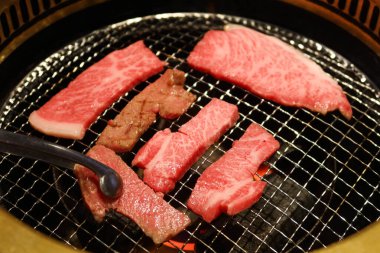 Izgara çiğ Japon Matsusaka sığır eti yakiniku ve yuvarlak ızgara.