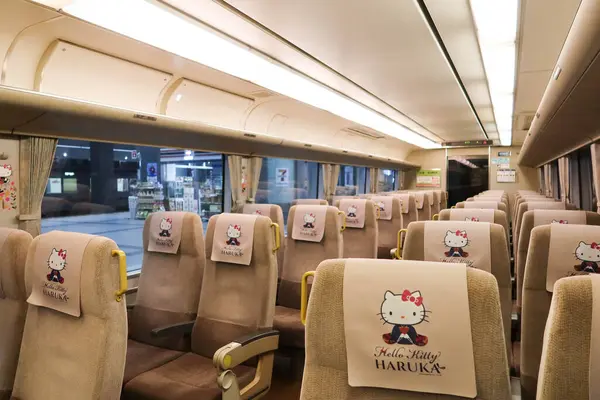 stock image Kansai, Osaka, Japan- 19 Jul 2024: Hello Kitty HARUKA train departs from Kansai International Airport to Osaka, Tokyo and Shin Osaka seats with no passengers.