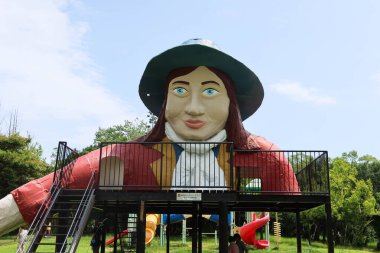 Ise, Mie, Japan- 20 Jul 2024: Toba Shimin-no-mori Park or can be called Citizen's Forest Park with a lady-like statue slide with fence and stairs clipart