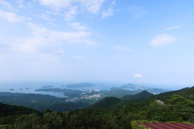 Mt. Asama, Ise, Mie, Japan- 19 Jul 2024: landscape view from the mountain top on a good weather day with blue sky showing islands and sea clipart