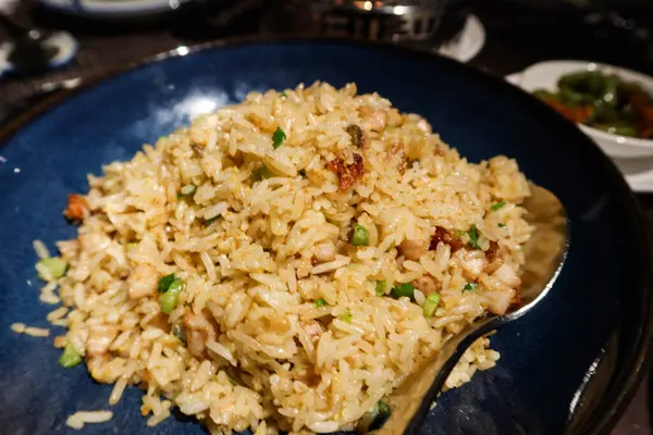 stock image close up of Chinese Cantonese Hong Kong style stir fried egg flat rice with salted fish and pork in a deep blue bowl