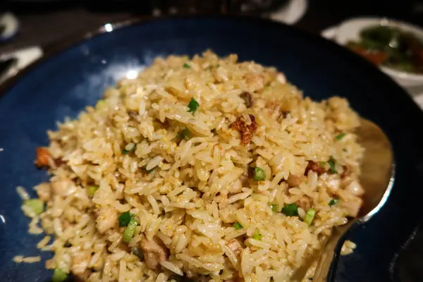 stock image close up of Chinese Cantonese Hong Kong style stir fried egg flat rice with salted fish and pork in a deep blue bowl