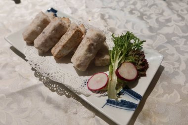 close up of Chinese chaozhou style Chiu Chow Deep-fried Taro tossed with Sugar on a white plate clipart