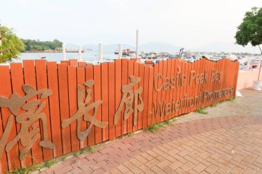 Tuen Mun, Hong Kong - 15 Eylül 2024: Castle Peak Bay Liman Alanı (Tsing Shan Wan) Çince ve İngilizce deniz kenarında gün batımı tabelasında