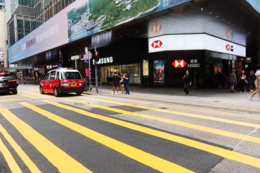 Central, Hong Kong- 18 Sep 2024: des voeux road traffic with cars, taxis and shops near by eg. HSBC bank or Breguet clipart