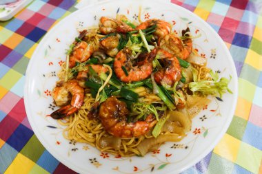 Hong Kong usulü Çin usulü ev yapımı karidesleri, beyaz tabakta yumurtalı erişteyle karıştırın.