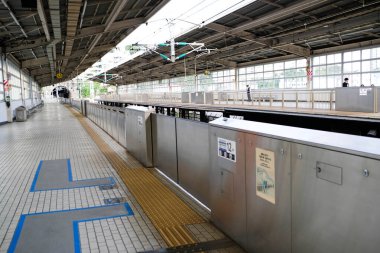 Atami, Japan- 30 Oct 2024: JR ( Japan Railway) Central N700 Shinkansen bullet train entering the station platform in daytime with high speend clipart