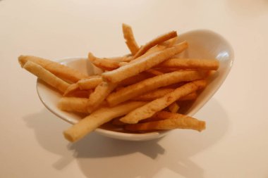 Kızarmış Kappa Ebisen (karides krakeri) beyaz bir tabakta fotokopi alanı olan abur cuburlar.