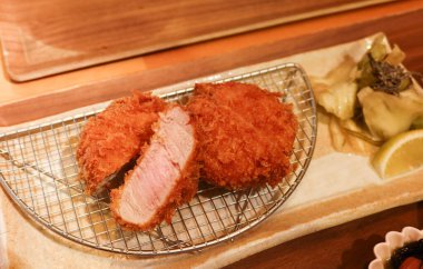 Japon usulü kızarmış domuz pirzolasının yarısını bir tabakta filtreye sığdırın.