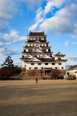 Fukuyama Castle, Fukuyama, Hiroshima, Japan- 10 Dec 2024: Japanese castle for fortress, war and protection in daytime with blue sky at sunset with park sand ground with copyspace clipart