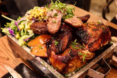 Peru usulü ızgara et, sığır filetosu, fırında tatlı patates, salata, tavuk, sucuk ve fırında sosis.