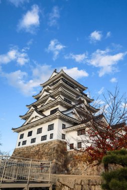 Fukuyama Castle, Fukuyama, Hiroshima, Japan- 10 Dec 2024: Japanese castle for fortress, war and protection in daytime with blue sky at sunset with park sand ground with copyspace clipart