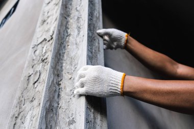 İnşaat işçisi son rötuşları yapıyor. Endüstriyel alan eylemi. Kapalı alanda çekilen yakın çekim görüntü işçiliği kavramı.