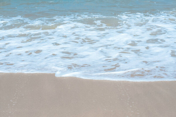 Sandy beach and soft blue Sea wave of the sea