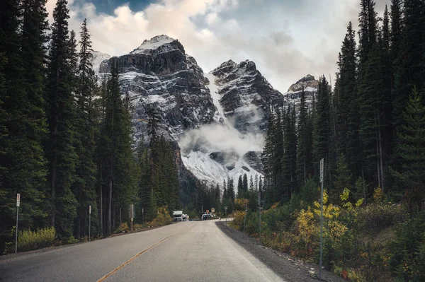 stock image Scenic road trip driving through rocky mountains and pine forest near Moraine Lake at Banff national park, AB, Canada