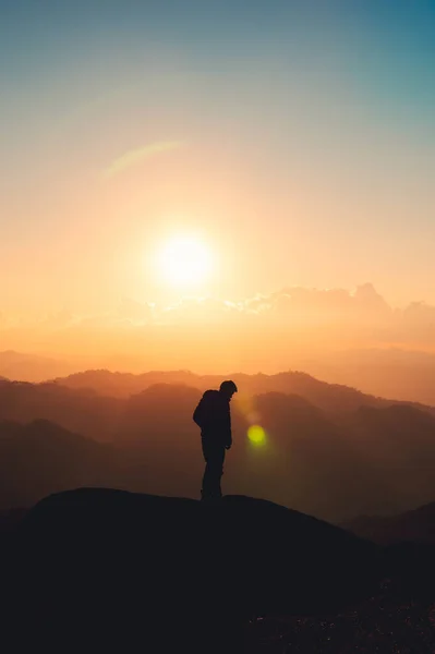 stock image Silhouette hiker man standing on top of mountain enjoying the beautiful sunset in national park