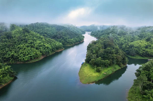 Stock image Aerial view of Abundance tropical rainforest with foggy and river flowing through in the morning at national park