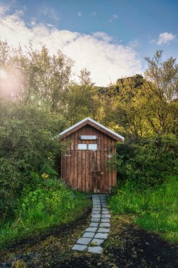 Rustic wooden hut in deep forest on national park at the sunset