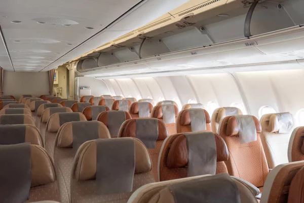 Row of commercial aircraft passenger seat and aisle cabin in airplan