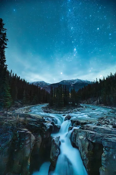 Night scene of Sunwapta Falls with glowing starry in the sky in Canadian Rockies during the autumn at Icefields Parkway, Jasper national park, Canada