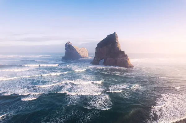 stock image Aerial view of Picturesque sunrise shining over Wharariki beach and archway island on Tasman sea at West of cape farewell, New Zealand