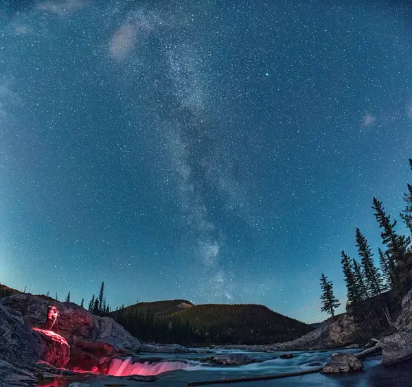 Stock image Landscape of Elbow Falls with milky way and photographer taking photo in the night at Kananaskis country, Canada