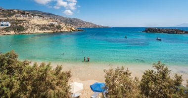 Lefkos Beach, Karpathos, Greece - August 2022 : White sandy beach and crystal clear water on a popular and beautiful greek beach