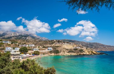 Lefkos Beach, Karpathos, Greece - August 2022 : White sandy beach and crystal clear water on a popular and beautiful greek beach
