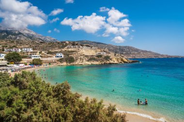 Lefkos Beach, Karpathos, Greece - August 2022 : White sandy beach and crystal clear water on a popular and beautiful greek beach