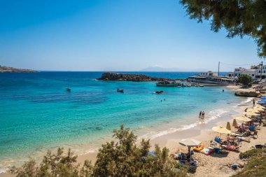 Lefkos Beach, Karpathos, Greece - August 2022 : White sandy beach and crystal clear water on a popular and beautiful greek beach