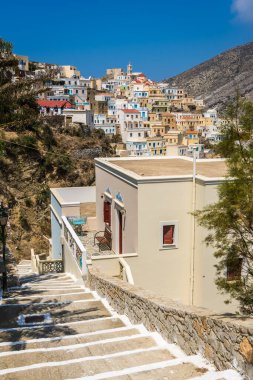 Olympos, Greece - August 2022 : Dwonhill stairwell to the homes in the old tradition village Olympos in Karpathos island, Dodecanese Greece