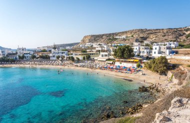 Lefkos Beach, Karpathos, Greece - August 2022 : White sandy beach and crystal clear water on a popular and beautiful greek beach