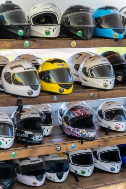 Crete, Greece - August 2022 : Shelves with motorcycle helmets in a bike rental shop