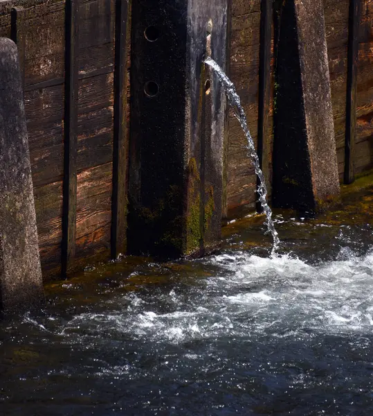 stock image Wooden and concrete, Weir Dam holds back the South Holston River.  Small round hole lets small stream escape.