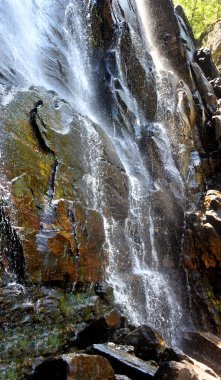 Closeup photo, taken at an angle, shows spray of Hickory Nut Falls, Chimney Rock State Park, North Carolina. clipart