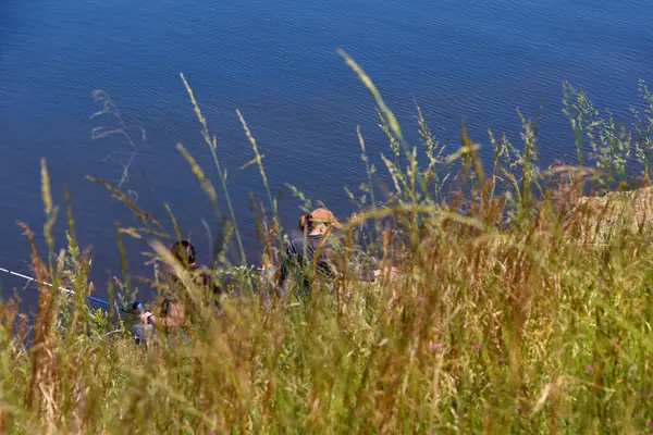 stock image Two women fish on the banks of Lake Claiborne.  They are hidden by the bank and tall grasses in their favorite, secret spot.