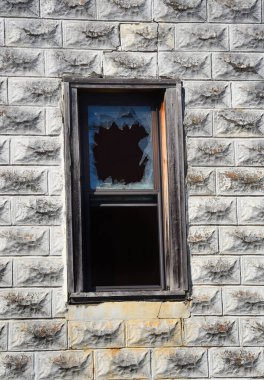 Background image shows a window in Pepper Sauce Alley, ghost town.  Window is faded and weathered wood with broken window pane showing shards of glass. clipart