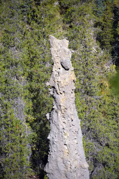 stock image Rocky, narrow, chimney formation stands tall at the Pinnacles Overlook, in Crater Lake National Park, in Oregon.