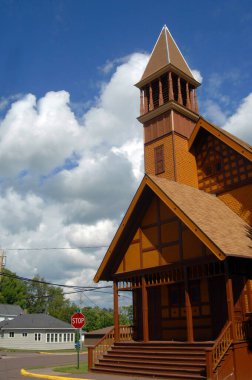 Historic, First Congregational Church of Lake Linden, Michigan, is composed of Victorian Stick Architecture.  Painted yellow and trimmed in brown, this church has a tower and belfry. clipart