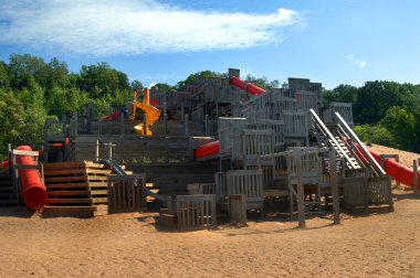 Landmark park, on Houghton, Michigan's waterfront, Chutes and Ladders is composed of orange chutes and black ladders of fun for the kids. clipart