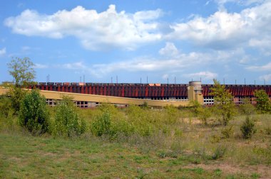 Train cars are lined up on a ore loading dock in Marquette, Michigan.   clipart